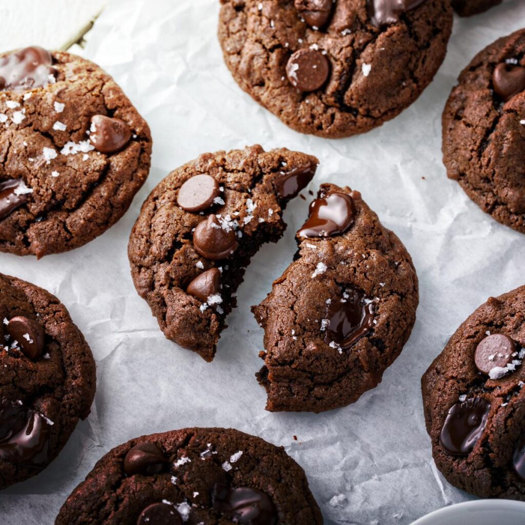 Seven chocolate chocolate chip cookies sprinkled with sea salt.